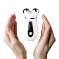 Contour Wand microcurrent device held in two hands, white background